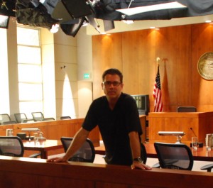 Michael Paul Clausen in a courtroom set he designed.